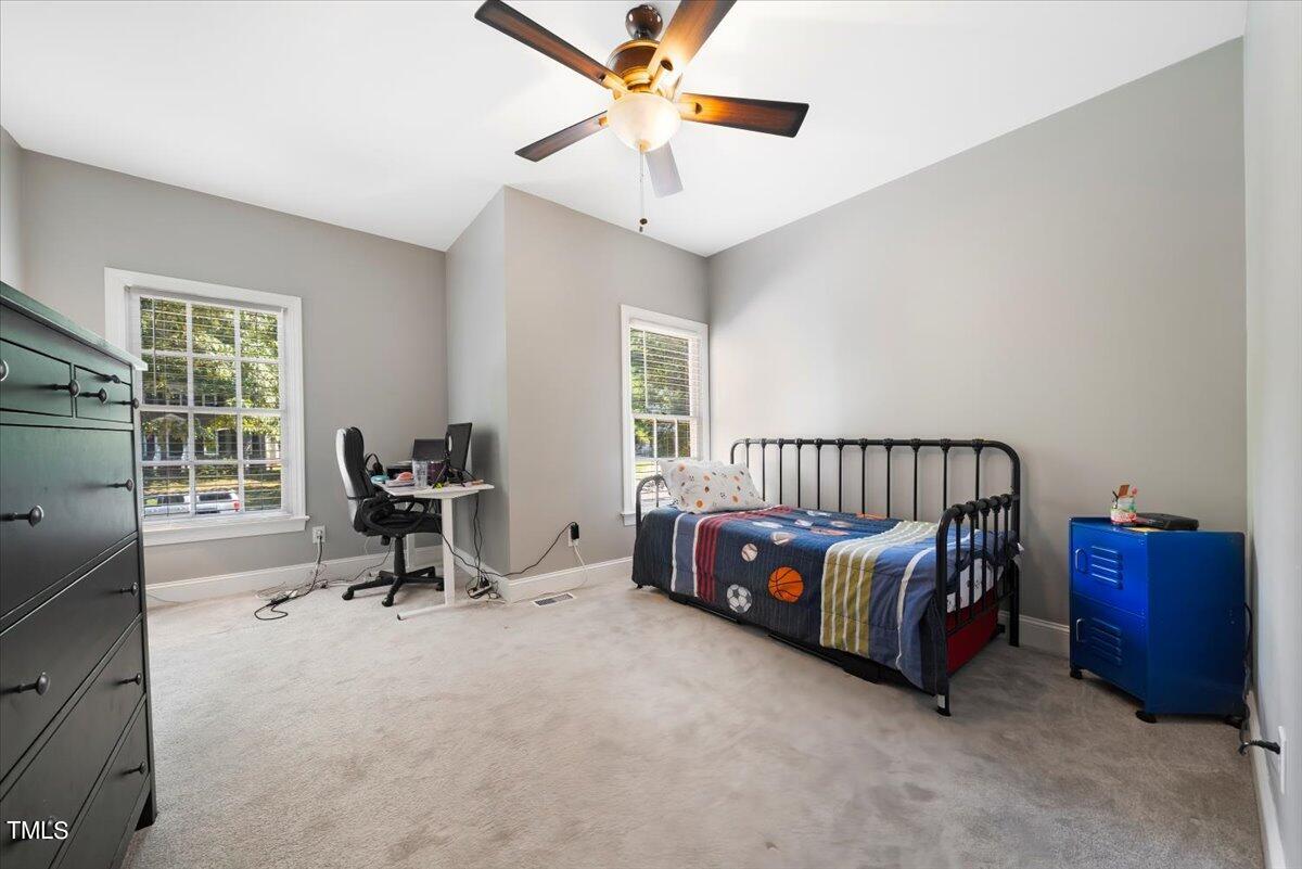 11905 Radner Way Raleigh, NC 27613 - Photo 15 of 35 a bedroom with a bed and a window