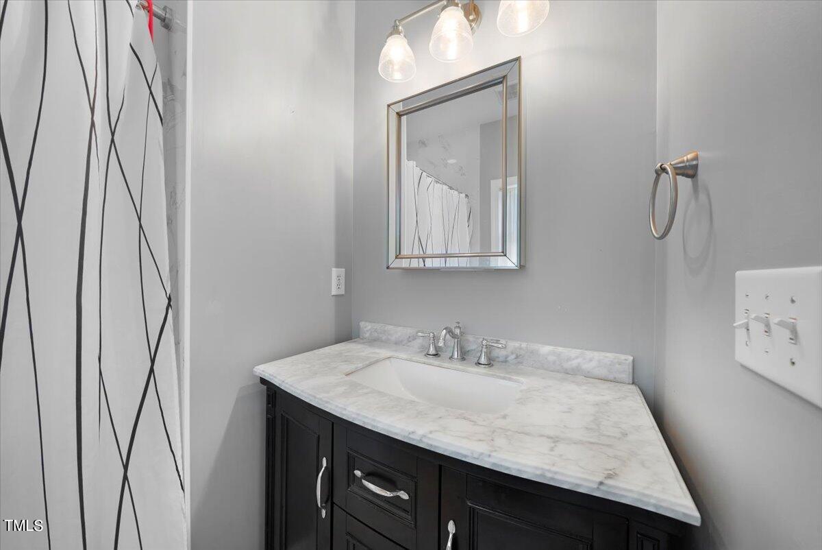 11905 Radner Way Raleigh, NC 27613 - Photo 18 of 35 a bathroom with a sink vanity and a mirror
