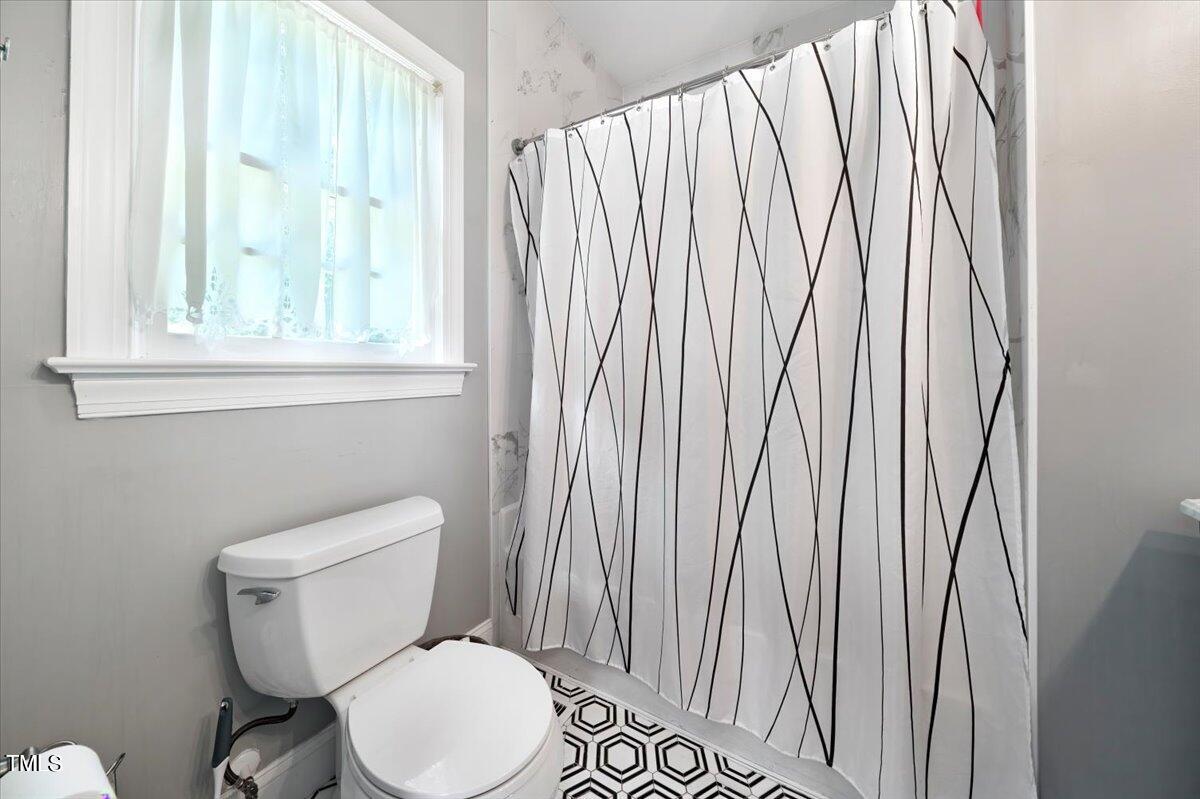 11905 Radner Way Raleigh, NC 27613 - Photo 19 of 35 a white toilet sitting next to a window