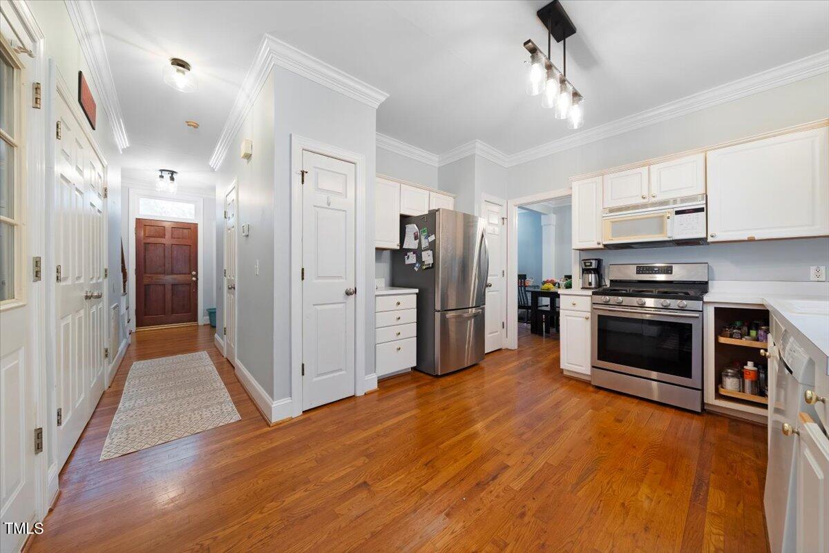 11905 Radner Way Raleigh, NC 27613 - Photo 3 of 35 a kitchen with stainless steel appliances a refrigerator a stove a sink and a center island
