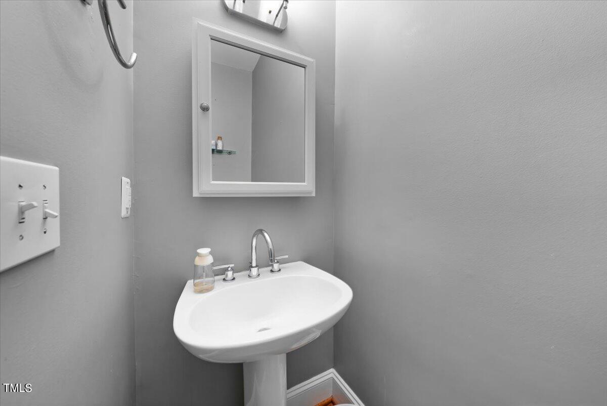 11905 Radner Way Raleigh, NC 27613 - Photo 7 of 35 a bathroom with a sink a mirror and a toilet