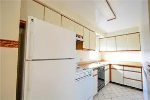 a white refrigerator freezer sitting inside of a kitchen