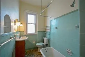 a bathroom with a sink mirror toilet and bathtub