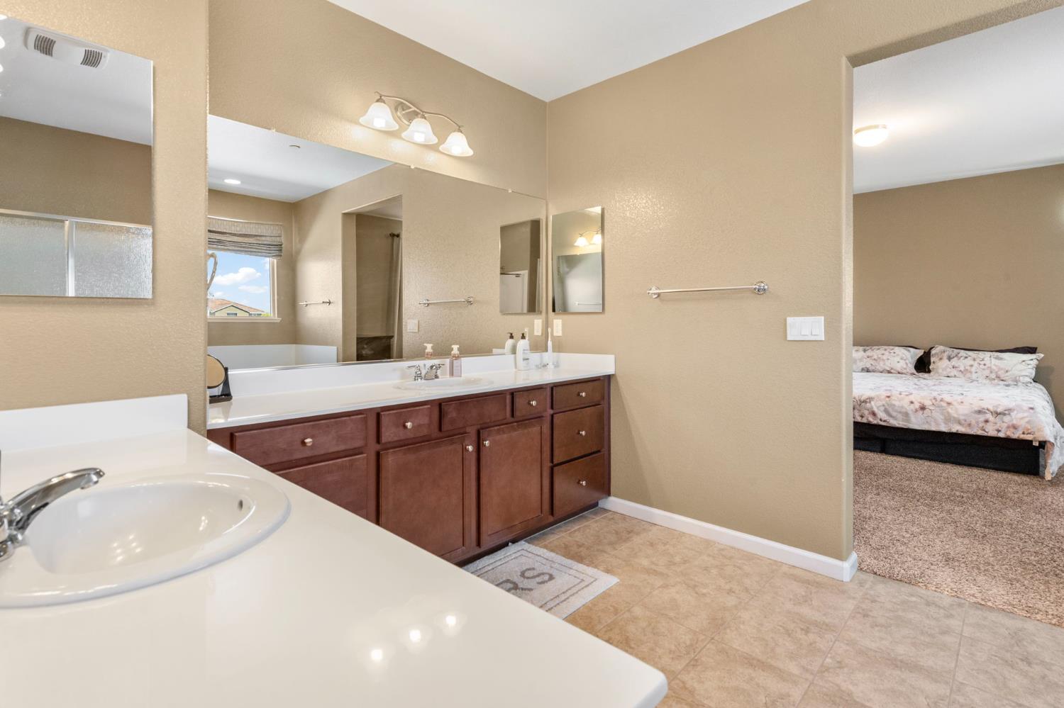 2317 Mathar Drive Manteca, CA 95337 - Photo 34 of 48 a en suite bathroom with a double vanity sink and a mirror