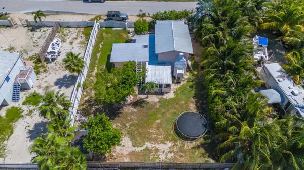 an aerial view of a house with swimming pool and garden view