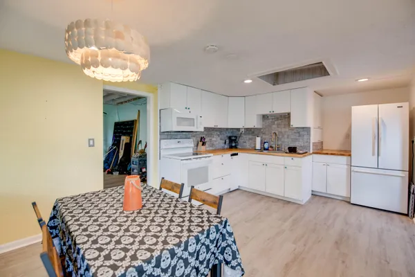 a kitchen with stainless steel appliances granite countertop a refrigerator sink and stove