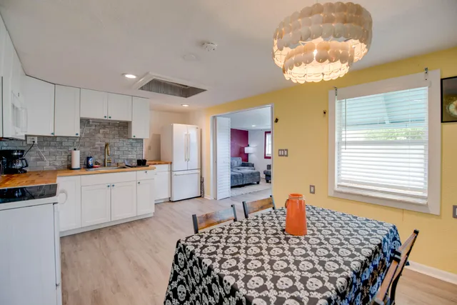a kitchen with stainless steel appliances granite countertop a sink and a refrigerator
