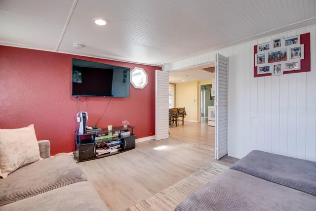 a living room with furniture and a flat screen tv
