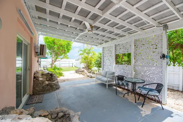 a building outdoor space with patio furniture and potted plants