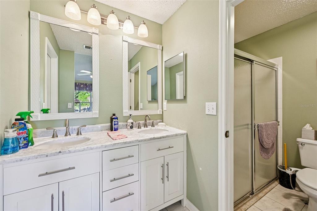 2215 Olive Branch Drive Sun City Center, FL 33573 - Photo 16 of 60 a bathroom with a sink vanity tub and shower