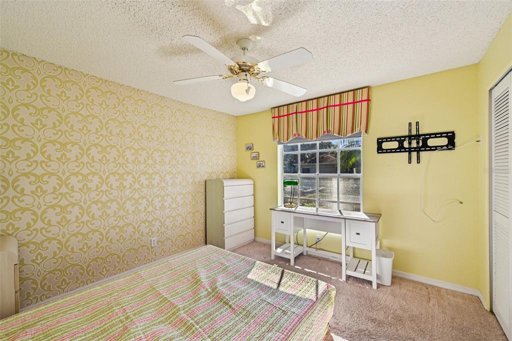 2215 Olive Branch Drive Sun City Center, FL 33573 - Photo 20 of 60 a bedroom with a bed and a window