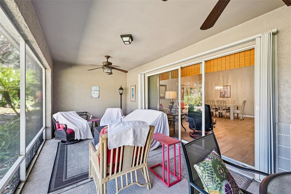 2215 Olive Branch Drive Sun City Center, FL 33573 - Photo 24 of 60 a living room with furniture and a floor to ceiling window