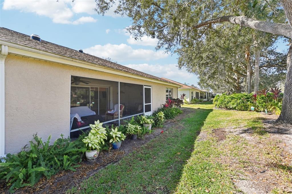 2215 Olive Branch Drive Sun City Center, FL 33573 - Photo 27 of 60 a front view of a house with a yard and potted plants