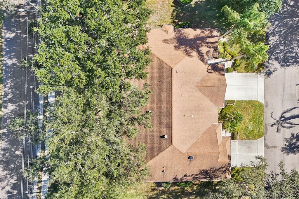 2215 Olive Branch Drive Sun City Center, FL 33573 - Photo 32 of 60 an aerial view of a house with a yard and covered with trees