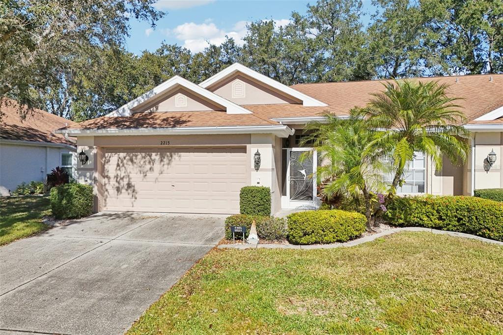 2215 Olive Branch Drive Sun City Center, FL 33573 - Photo 56 of 60 a front view of a house with garden