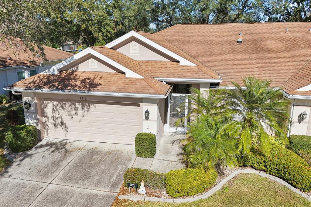 2215 Olive Branch Drive Sun City Center, FL 33573 - Photo 58 of 60 a aerial view of a house with a yard and potted plants