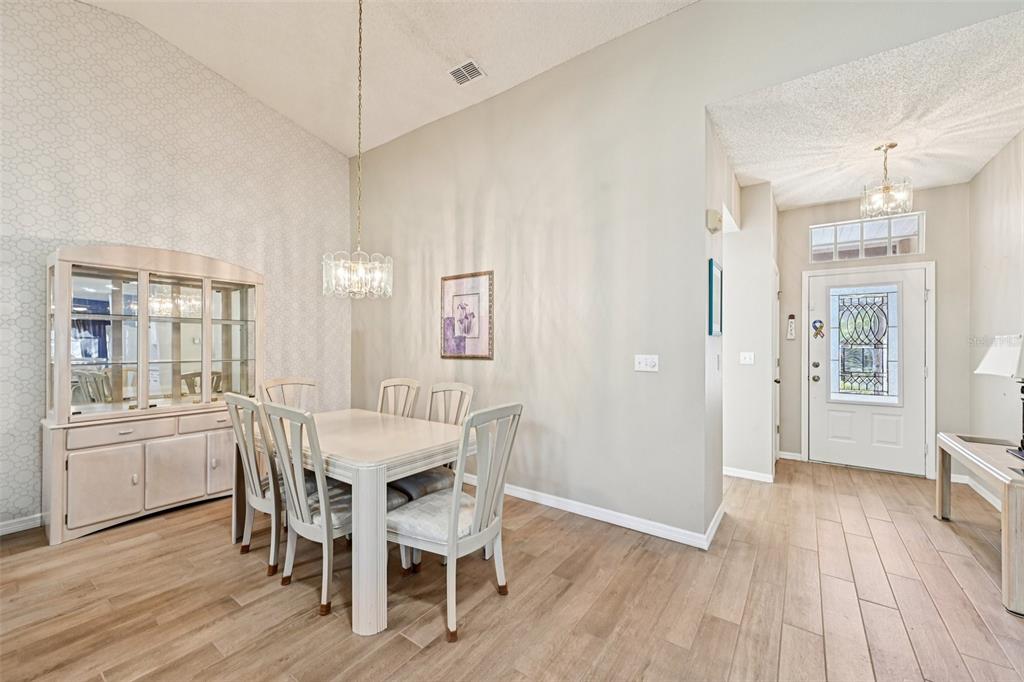 2215 Olive Branch Drive Sun City Center, FL 33573 - Photo 6 of 60 a view of a dining room with furniture window and wooden floor
