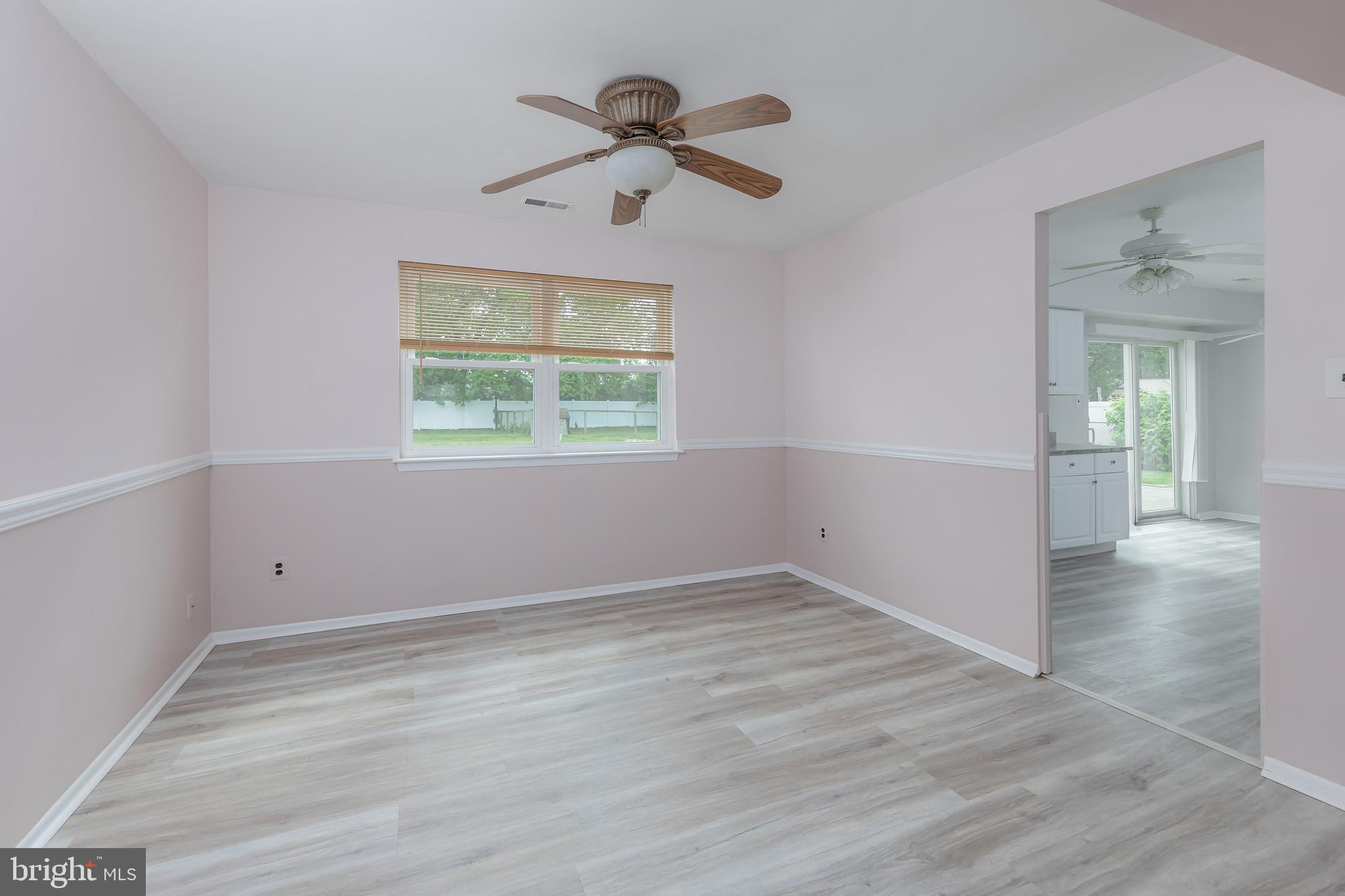 75 Hartford Road Sewell, NJ 08080 - Photo 11 of 23 an empty room with wooden floor chandelier fan and windows