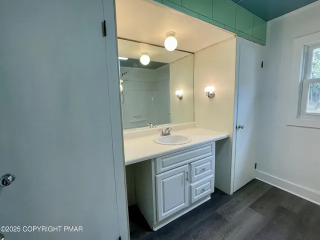 a spacious bathroom with a double vanity sink and a mirror