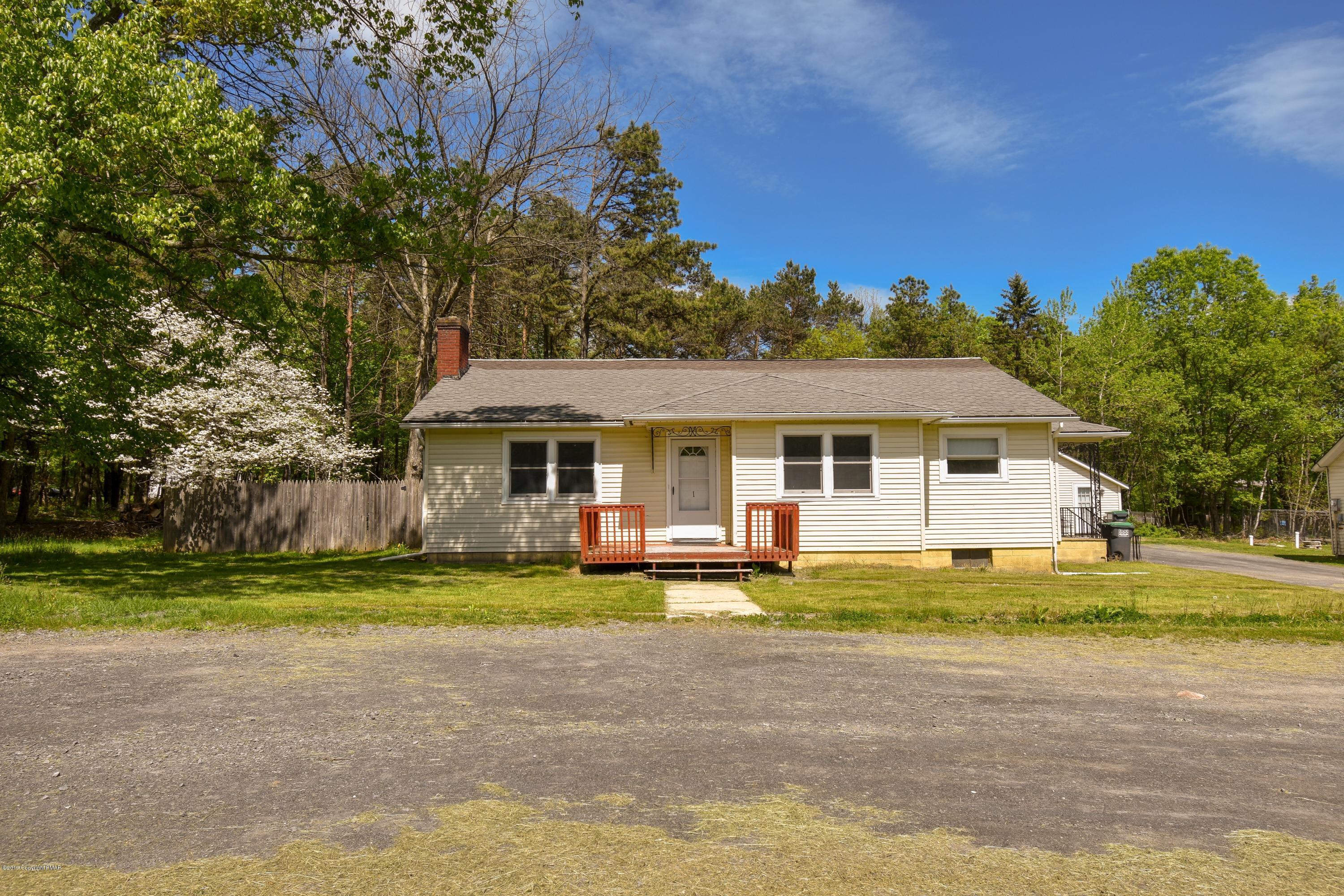 3284 Highway 115, Unit 1 Effort, PA 18330 - Photo 2 of 17 a front view of a house with a yard and trees
