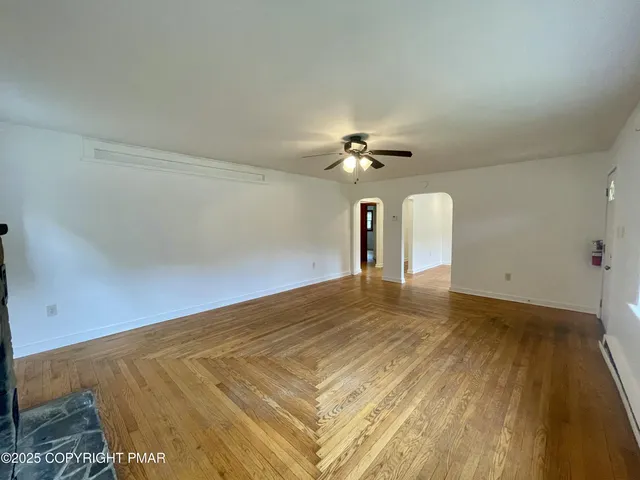 a view of empty room with ceiling fan
