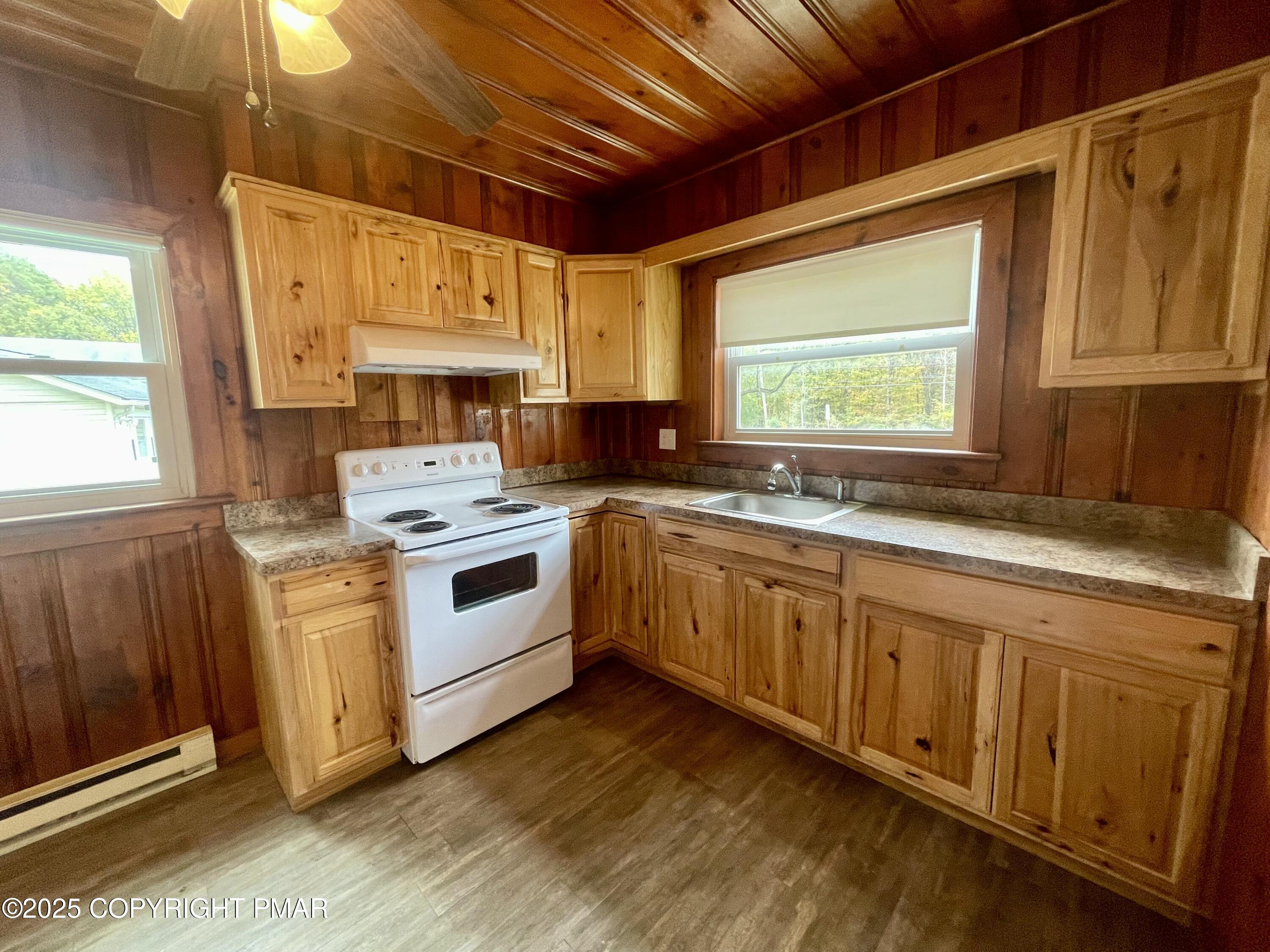 3284 Highway 115, Unit 1 Effort, PA 18330 - Photo 8 of 17 a kitchen with granite countertop a sink stainless steel appliances cabinets and a window