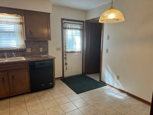 a kitchen with a cabinets and chandelier