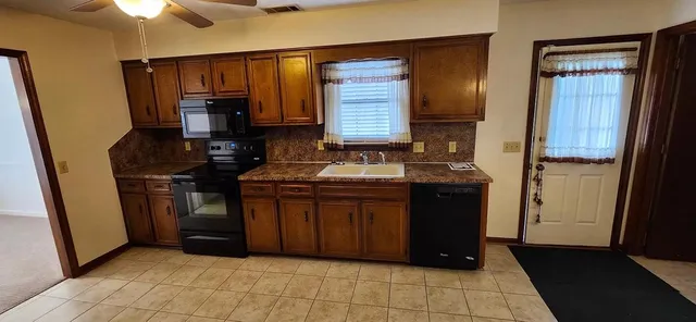 a kitchen with a sink and cabinets