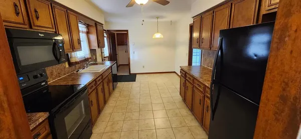 a kitchen with stainless steel appliances a refrigerator and a stove top oven