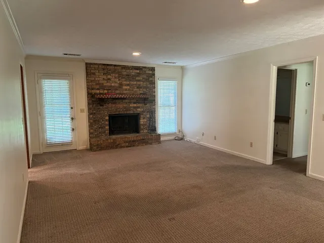 a view of empty room with a fireplace