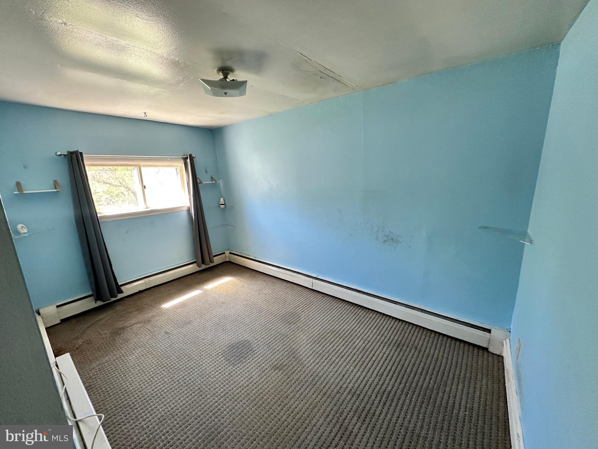 360 West Paletown Road, Unit 1R Quakertown, PA 18951 - Photo 4 of 6 an empty room with windows and hardwood floor