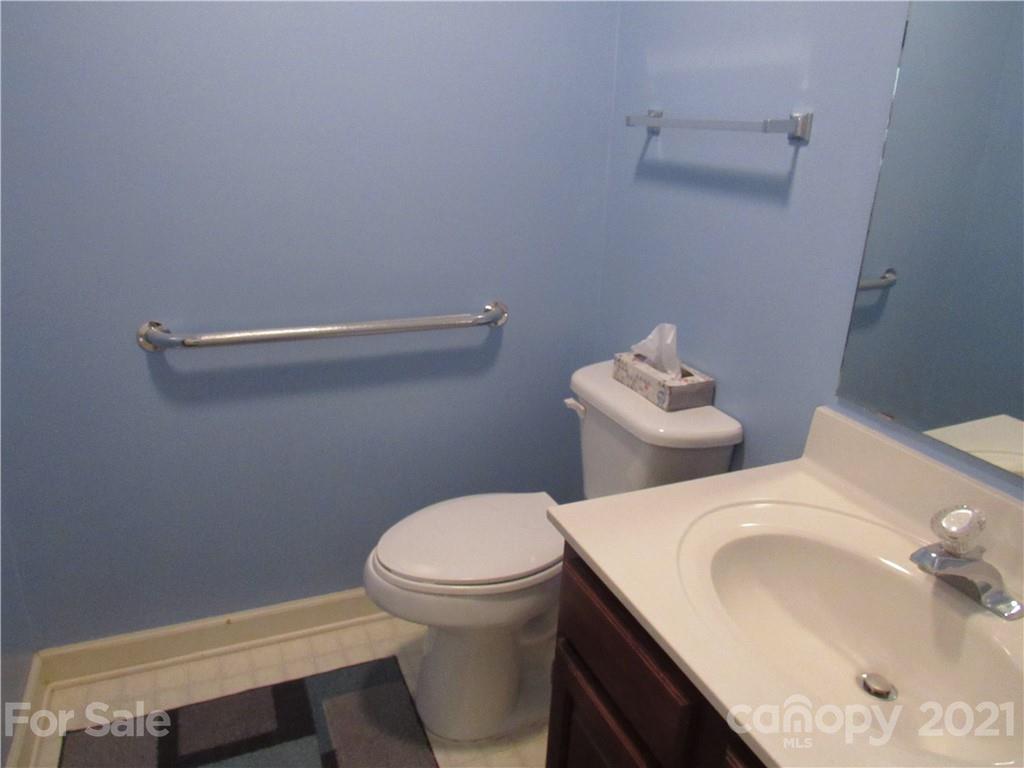 109 Carpenter Lane Rutherfordton, NC 28139 - Photo 12 of 28 a white toilet sitting next to a bathroom sink