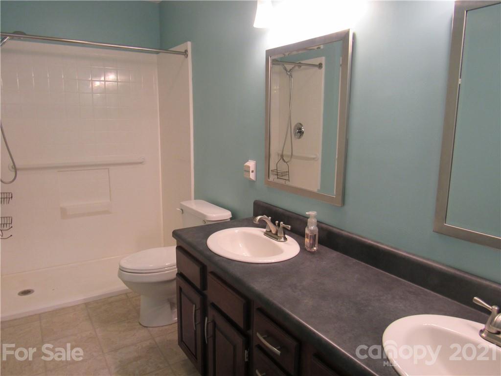 109 Carpenter Lane Rutherfordton, NC 28139 - Photo 15 of 28 a bathroom with a granite countertop sink a toilet and a mirror