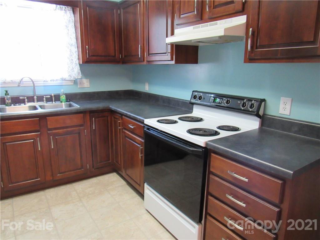 109 Carpenter Lane Rutherfordton, NC 28139 - Photo 10 of 28 a kitchen with a sink a stove and cabinets
