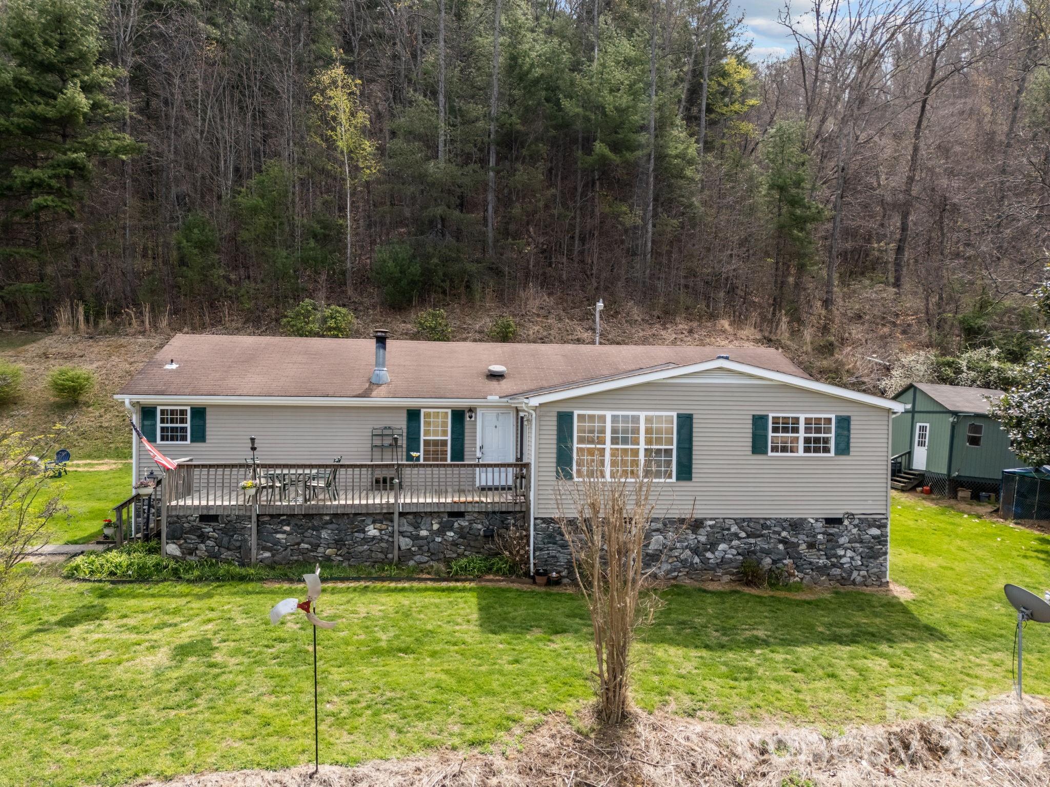 74 Chambers Road Weaverville, NC 28787 - Photo 1 of 43 a front view of a house with a yard table and chairs