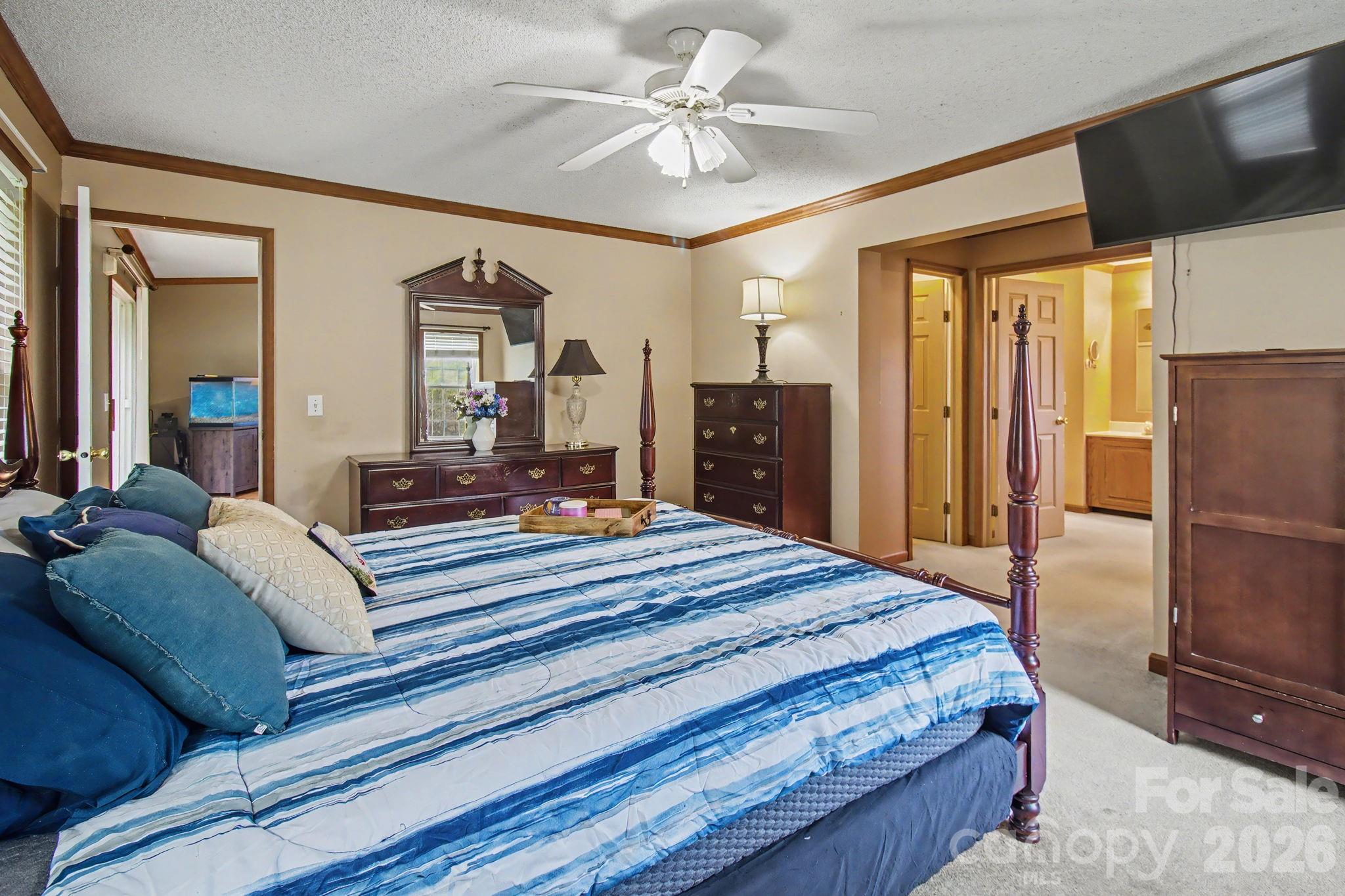 74 Chambers Road Weaverville, NC 28787 - Photo 22 of 43 a bedroom with a large bed and a chandelier