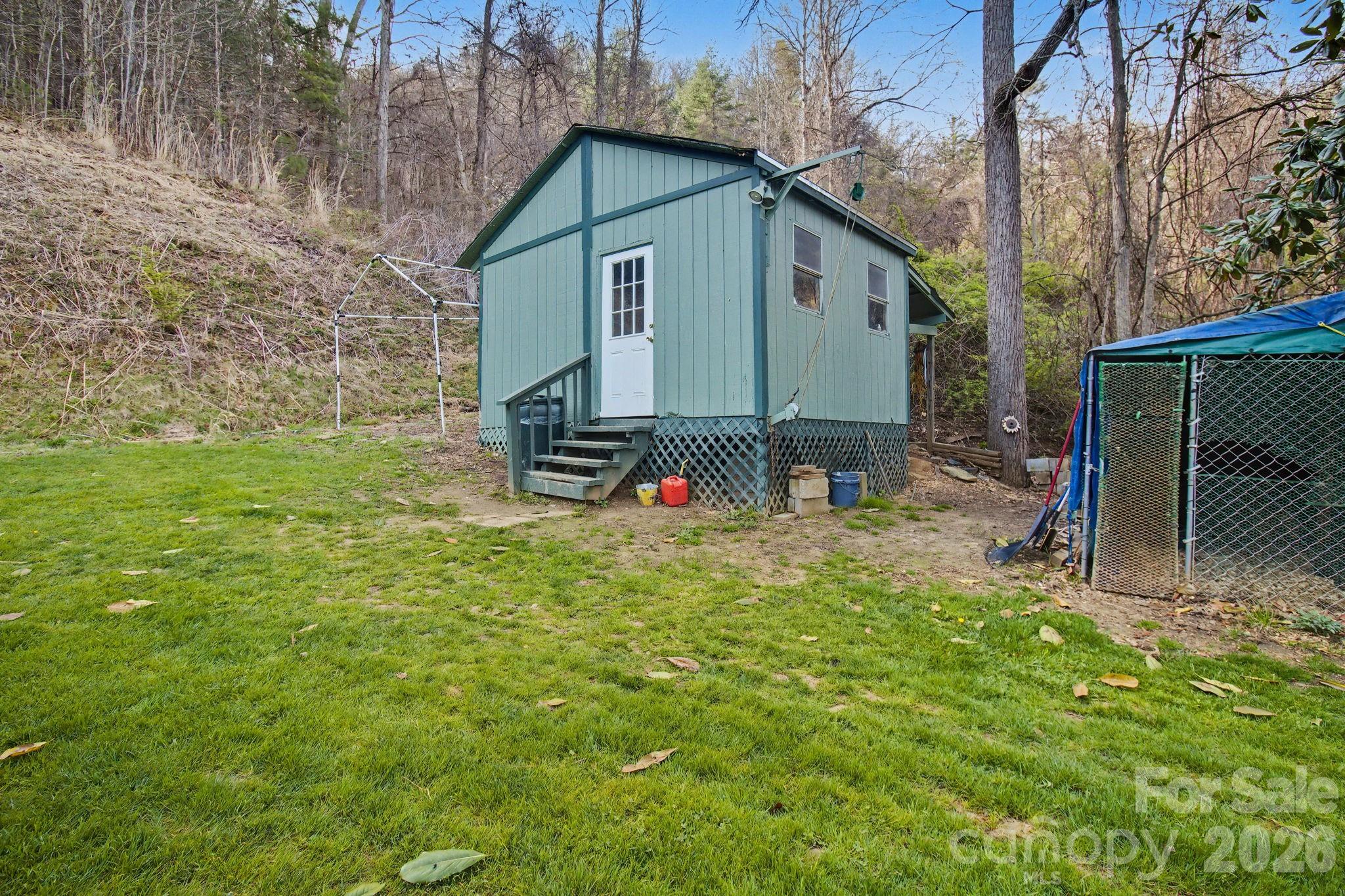 74 Chambers Road Weaverville, NC 28787 - Photo 38 of 43 a backyard of a house with table and chairs