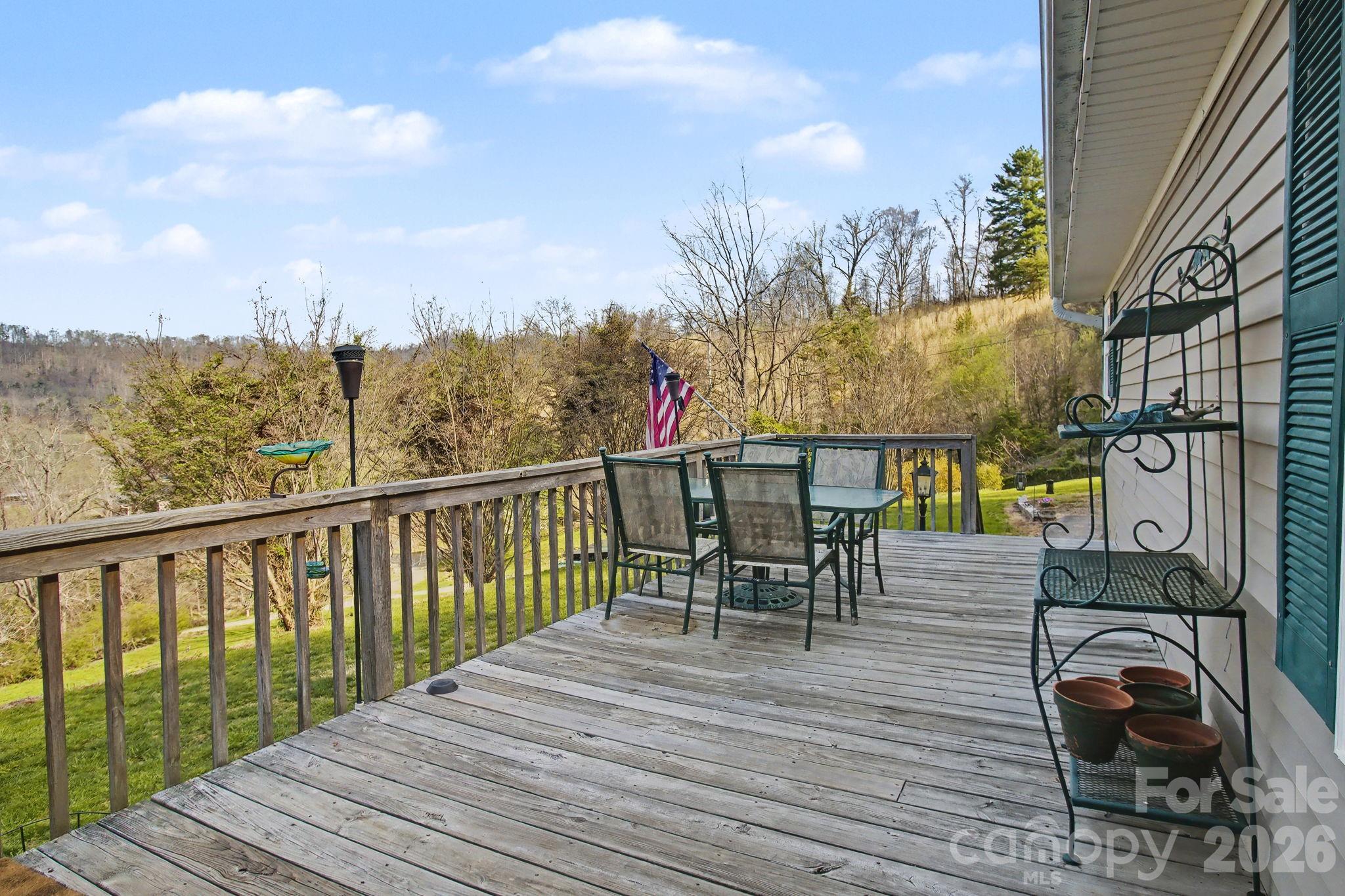 74 Chambers Road Weaverville, NC 28787 - Photo 10 of 43 a view of a balcony with dining table and chairs with wooden floor