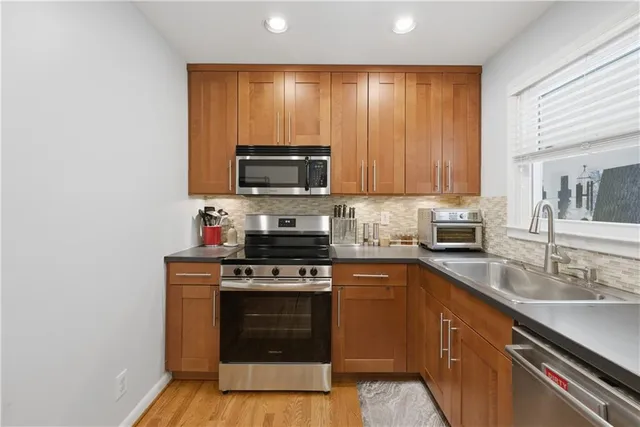 a kitchen with a stove a sink and a microwave