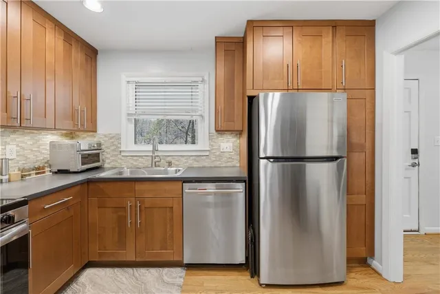 a kitchen with a refrigerator sink and cabinets