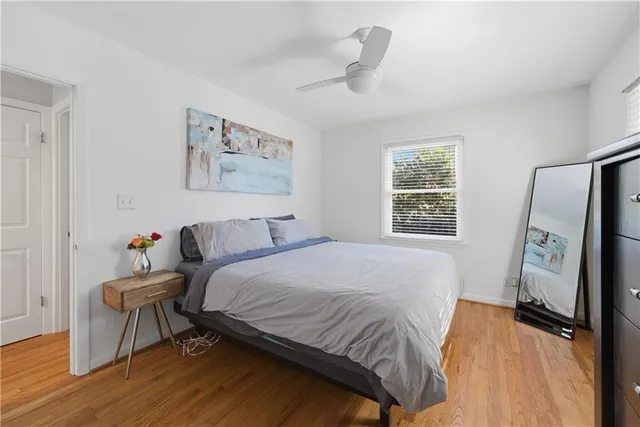 a bedroom with a bed and a flat tv screen on the dresser