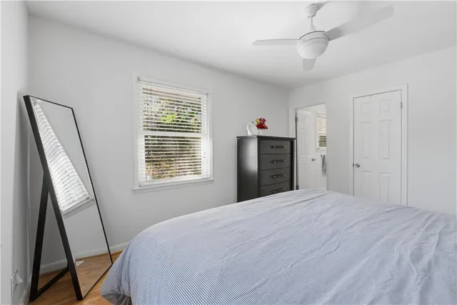 a bedroom with a bed and a flat tv screen on the dresser