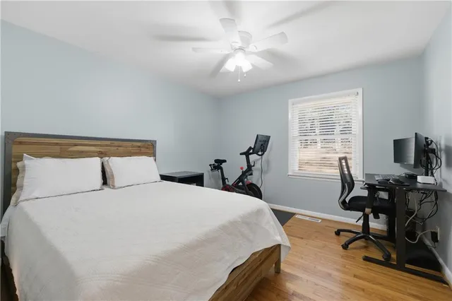 a bedroom with a bed a table and a workspace