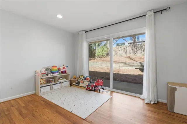 a view of a room with wooden floor and a window