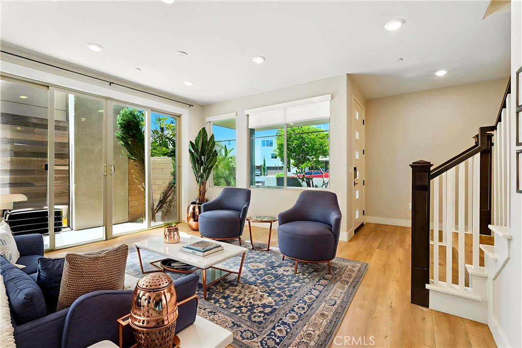 186 Stellar Irvine, CA 92618 - Photo 11 of 46 a living room with furniture large windows and wooden floor