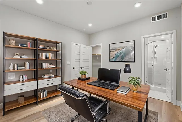 a living room with furniture flat screen tv and a table