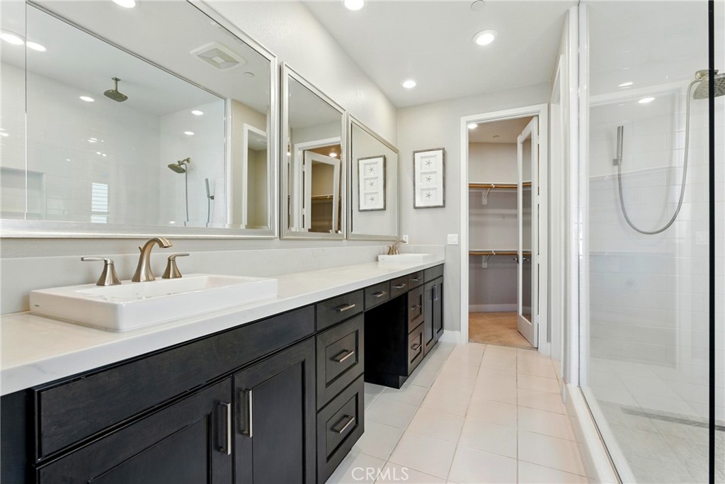 186 Stellar Irvine, CA 92618 - Photo 17 of 46 a spacious bathroom with a shower sink and mirror
