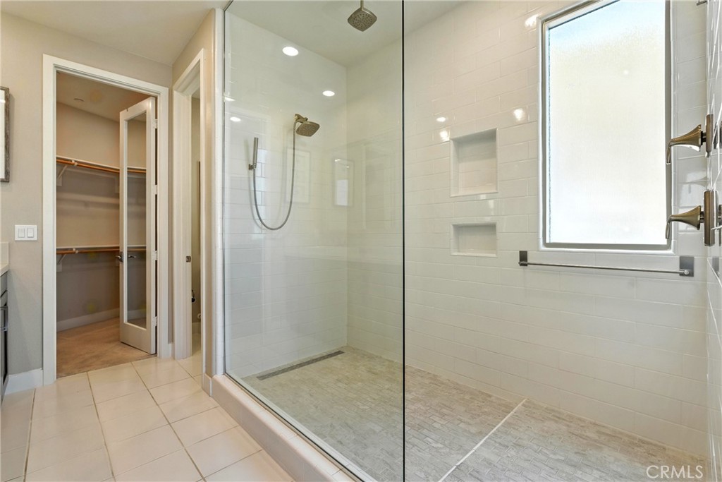 186 Stellar Irvine, CA 92618 - Photo 18 of 46 a bathroom with a shower and a glass door