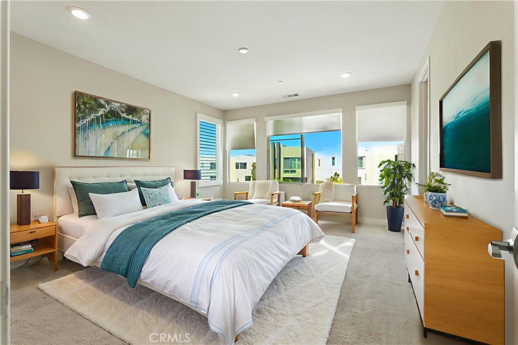 186 Stellar Irvine, CA 92618 - Photo 21 of 46 a spacious bedroom with a large bed a flat screen tv and a couch