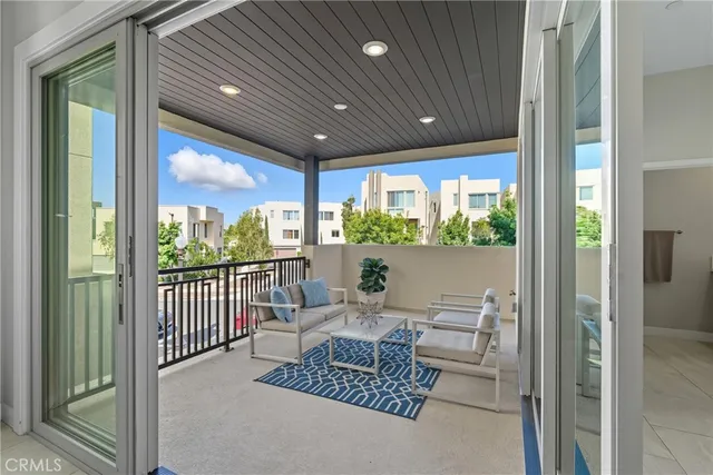 a living room with furniture and a floor to ceiling window